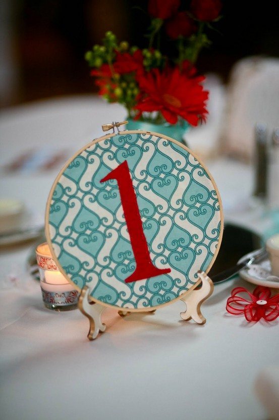 Make table numbers out of an embroidery hoop like this one from Charmingly